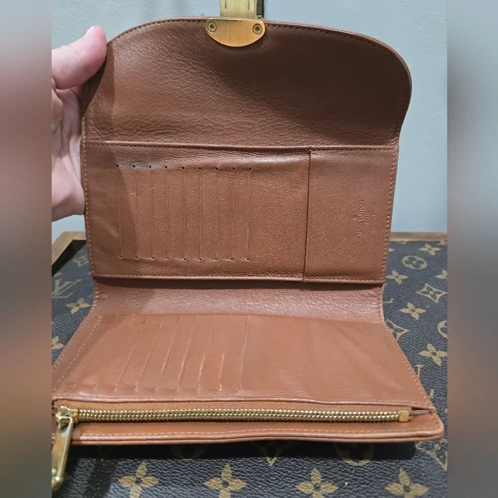 Authentic Louis Vuitton Mahina Amelia Wallet Monogram in brown leather.